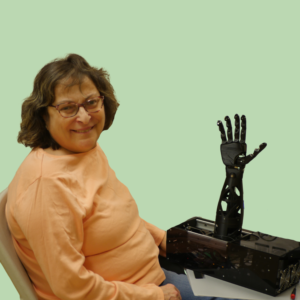 Marianne poses with the Tatum T1 Robotic Hand module.